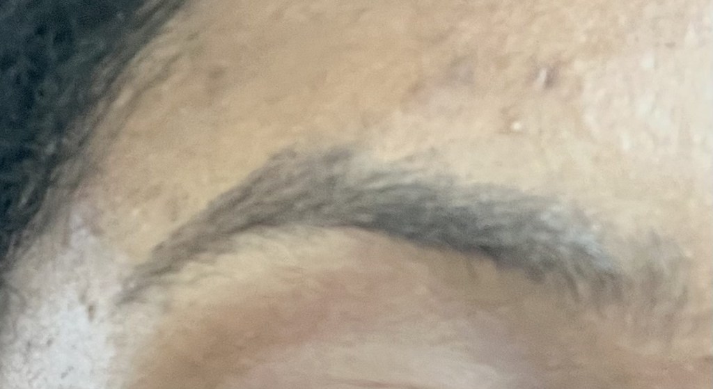 Picture of Revlon Brow Fantasy Dark Brown on a person with brown skin.
