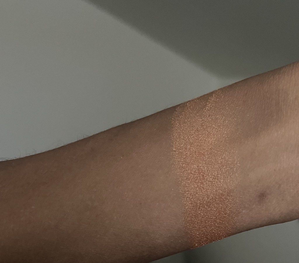 Mac Mineralize Skin Finish Gold Deposit swatch on brown skin.