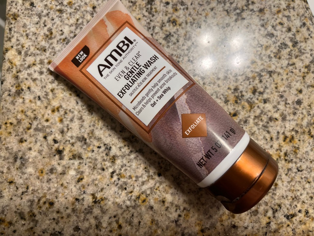 A tube of Ambi gentle cleansing face wash on a bathroom counter.