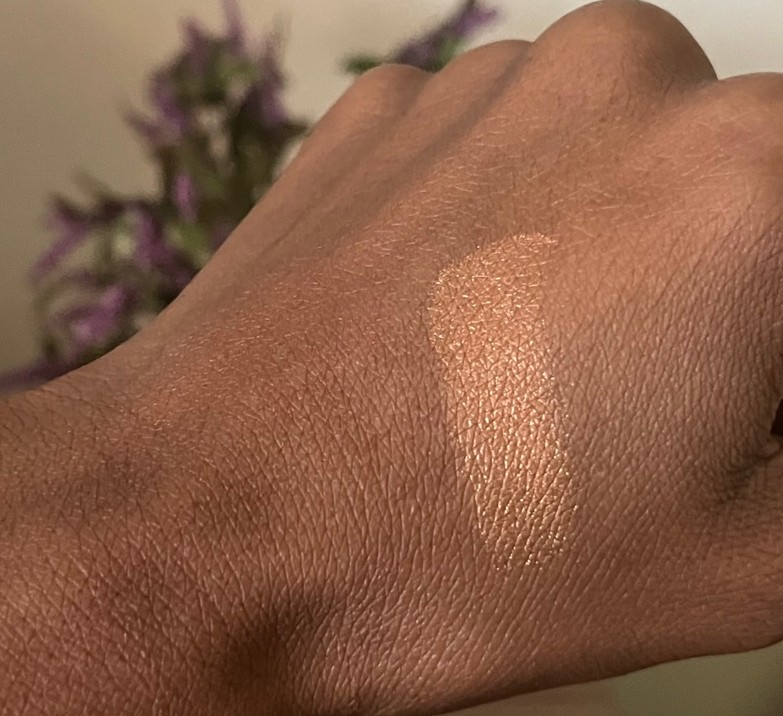 Mac mineralize skin finish gold deposit swatched on brown skin.