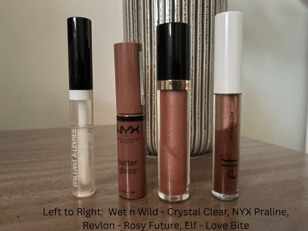 A lineup of drugstore lip glosses both neutrals and clear.