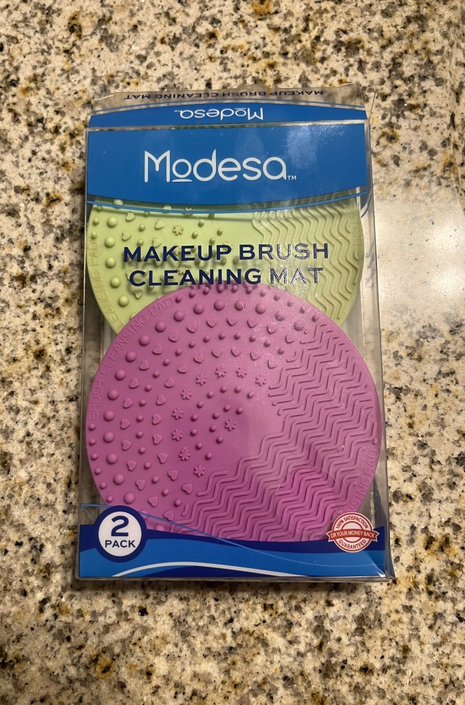 Flat textured makeup brush cleaning pads for brush scrubbing.