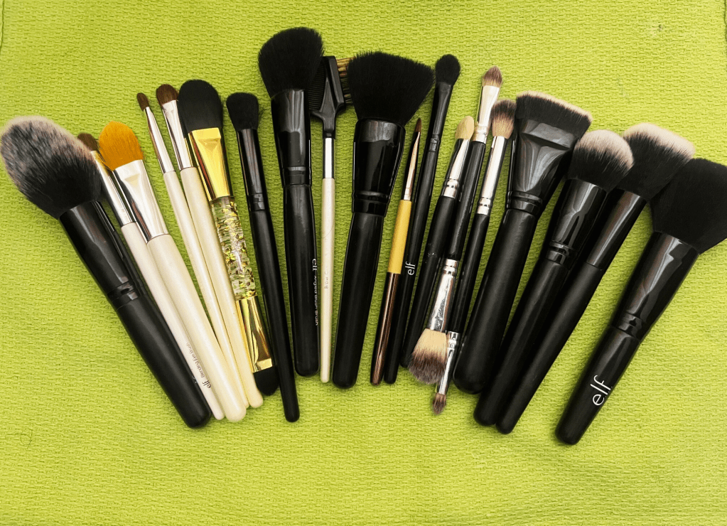 Clean makeup brushes laid on a towel to dry.