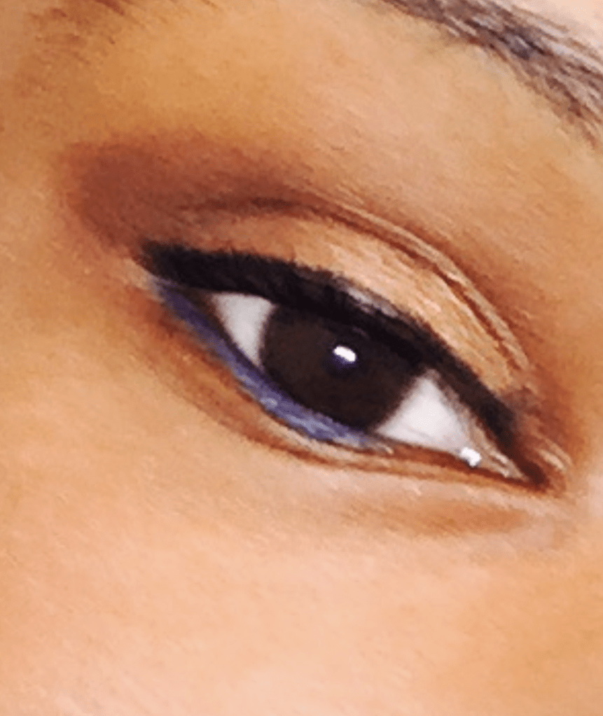 Gold, brown and blue eyeshadow on a brown skinned wearer.