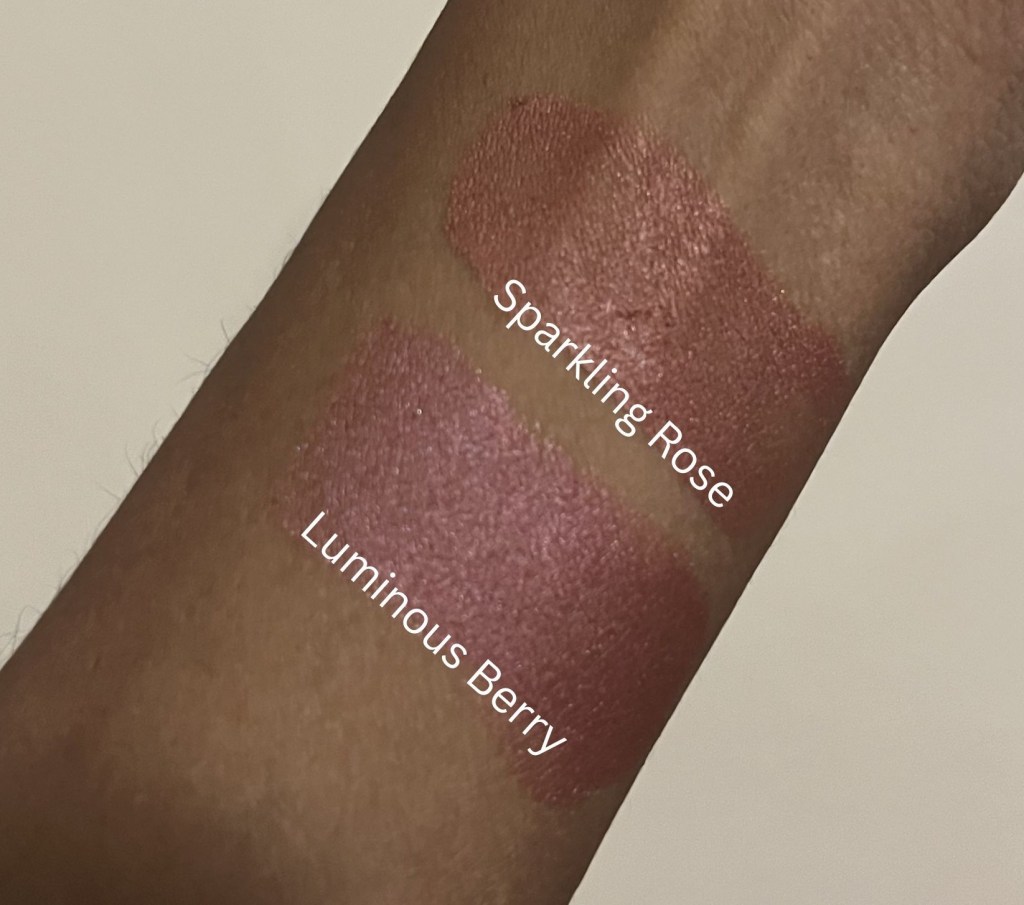 Swatches of elf monochromatic multistick on brownskin in the shades Sparkling Rose and Luminous Berry.