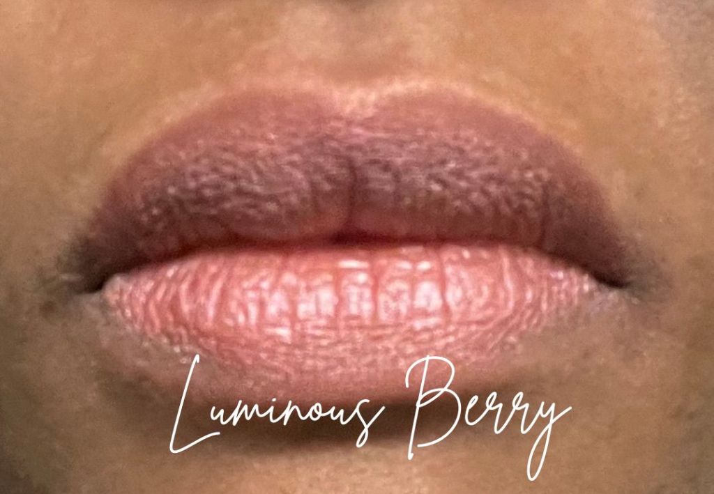 e.l.f. Monochromatic multi-stick in the color Luminous Berry worn as a lip product on brown skin.