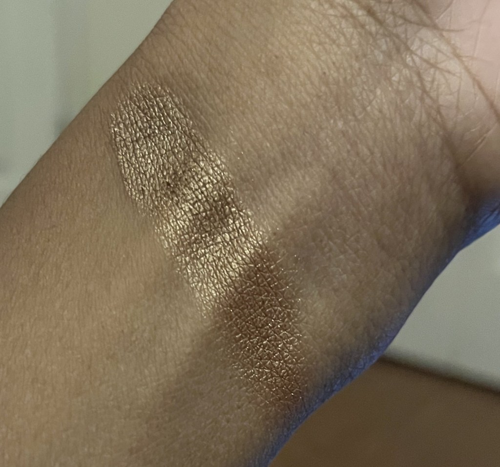 Mac Woodwinked swatched on the wrist on brown skin.